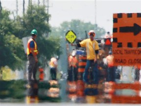 Paving workers seen through heat waves in July 2010. (Windsor Star file photo)