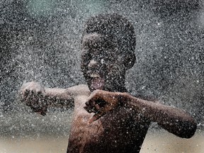 Ronaldo Asy cools off in the spray pad at Windsor Water World in this 2010 file photo. (Tyler Brownbridge / The Windsor Star)