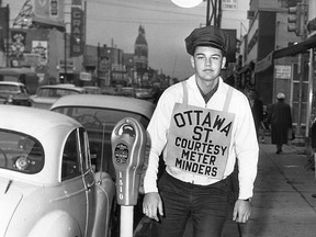 OCT.6/1962-Three roller skating high school students will be on duty on Ottawa St. every Friday night and Saturday night until Christmas, plugging parking metres. Dean Holmes seen here was out feeding the metres today. (The Windsor Star-FILE)