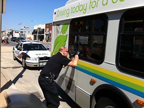 Ident Officer Darren Smith takes prints of bus window  in Windsor on Tuesday, June 12, 2012.           (Windsor Star / Nick Brancaccio)