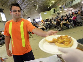 The annual Poor Boy Luncheon was held Friday, June 1, 2012, at the downtown Armouries. A steady crowd took in the event. Gus Moscatello took in the event and a pulled chicken sandwich. (DAN JANISSE/ The Windsor Star)