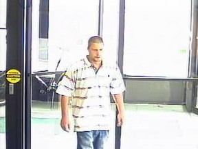 Surveillance photo of Joseph David  Reid who is wanted on two counts of robbery.