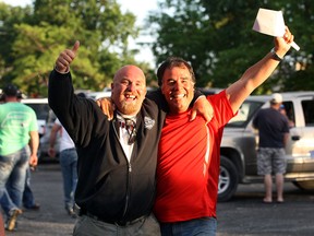 Fred Doughty (L) and George Pedro, members of the International Union of Operating Engineers local 793 celebrate after accepting a contract offer Wednesday, June 6, 2012, ending their strike.