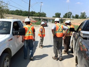 Parkway and Hydro officials gather on Malden Road as repairs to a broken pole holding power lines are planned. (Nick Brancaccio/The Windsor Star)