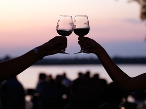 Files: A man and woman toast with wine glasses at the Shores of Erie Wine Festival held at Fort Malden in Amherstburg, Ont., in this file photo.  (JASON KRYK/The Windsor Star)