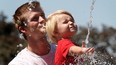 In this file photo, James Hodgson and his son Pearson, 2, get a little relief from the heat Aug. 18, 2010, at the fountain at Dieppe Gardens in downtown Windsor, Ont. (DAN JANISSE/The Windsor Star)