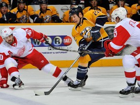 Jordin Tootoo, centre, skates between Henrik Zetterberg and Valtteri Filppula at the Bridgestone Arena in Nashville. (Frederick Breedon/Getty Images)