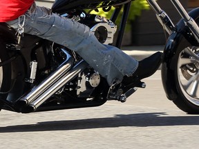 A motorcycle rider rumbles past pedestrians on University Avenue at Ouellette Avenue Friday July 20, 2012. (Nick Brancaccio/The Windsor Star)
