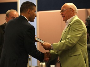 Larry Duffield (R) of Windsor, Ont. accepts the "Senior of the Year Award" at a Windsor city council meeting Monday, July 23, 2012, from Mayor Eddie Francis. (Windsor Star / DAN JANISSE)