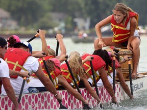 A woman beats the drum for her team as they compete at the 10th annual International Dragon Boats for the Cure, Sunday, July 15, 2012. (DAX MELMER/The Windsor Star).