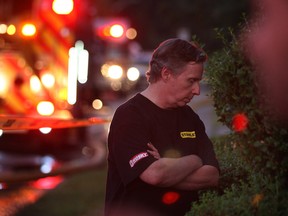 Windsor firefighters responded to a house fire Tuesday, July 3, 2012, in the 600 block of Moy Ave. The fire occurred at approximately 8:00 p.m. Neighbours reported seeing lightning striking the house. The owner of the home, shown here, and his dog exited without injury. (Windsor Star / DAN JANISSE)