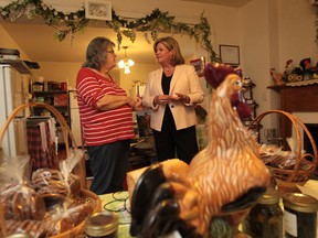 Ontario NDP leader Andrea Horwath, right, talks with Mary Ann Cuderman, chairwoman of the Olde Sandwich Towne BIA in Windsor, Ontario on July 27, 2012. (Jason Kryk/The Windsor Star)