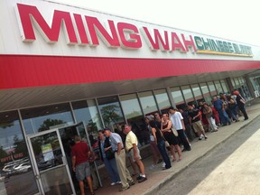 Hungry customers line up outside Ming Wah Chinese Buffet on July 25, 2012. (Dax Melmer/The Windsor Star)