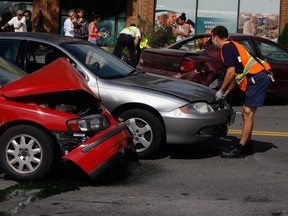 Windsor firefighters and Essex-Windsor EMS paramedics attend a three-vehicle collision where four patients were transported to hospital on Ouellette Avenue at Ellis Street, Thursday July 26, 2012. (Nick Brancaccio/The Windsor Star)