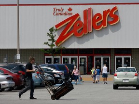 Biran Futko, front leff, of Canadian Bread Demsters, heads back to his truck after a delivery at Tecumseh Mall where Zellers is scheduled to close. (Nick Brancaccio/The Windsor Star)