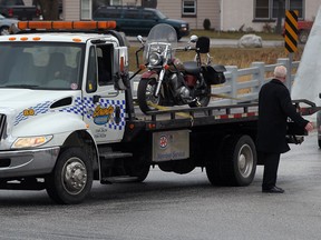 In this file photo, Paul Rocheleau's motorcycle was carried on the back of a flatbed tow truck in a procession of tow trucks at St. Joseph Catholic Church in River Canard for Rocheleau's funeral Monday Jan. 23, 2012. (NICK BRANCACCIO/The Windsor Star)