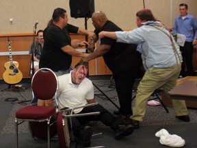 Wrestler Devon (Hannibal) Nicholson appears bloody (white shirt) after confronting Abdullah the Butcher (middle, black shirt) in Ottawa in 2007 to promote an upcoming show.