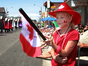 Jadilyn Palermo, 9, waves her Canadian flag as she watches the Canada Day Parade on Wyandotte Street east, Sunday, July 1, 2012.  (DAX MELMER/The Windsor Star)