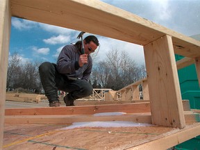 A carpenter works on a home in Tecumseh, Ont. in this March 2001 file photo. (Nick Brancaccio / The Windsor Star)