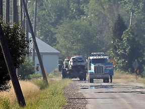 Tow trucks clear the scene of a rollover accident on North Talbot Road north of Essex on Monday, July 16, 2012. (TYLER BROWNBRIDGE/The Windsor Star)