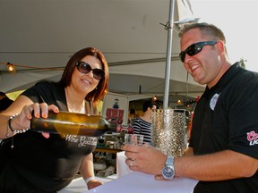 WINDSOR, ONT., July 7, 2012 -- Mastronardi Estate Winery owner Eadie Mastronardi pours a glass of wine for Chris Mickle at the first annual Fork and Cork Festival at Riverfront Plaza on Saturday, July 7, 2012. Mickle was one of the three organizers for the event, which was sparked after it was announced that Festival Epicure was cancelled. (REBECCA WRIGHT/ The Windsor Star)