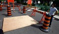 Pierre Avenue resident John Mazza stands by the covered mouth of a sinkhole on his street in Windsor, Ont. Photographed July 23, 2012. (Nick Brancaccio / The Windsor Star)