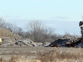 In this file photo, a track hoe moves material behind a home on Howard Avenue in Amherstburg, Ont. on Wednesday, Dec. 28, 2011. The Jones Group, which owns the lot, may be forced to pay up to $4 million in fines for using the site as an illegal dump. (TYLER BROWNBRIDGE / The Windsor Star)