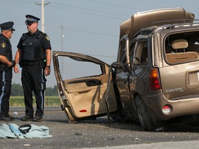OPP officers inspect the scene of a two-car collision on Highway 3 and County Road 27 in Kingsville, Ont., Wednesday, July 18, 2012. Five people, all occupants of a GMC Envoy, have been rushed to Hotel-Dieu Grace Hospital in Windsor, Ont. (DAX MELMER/The Windsor Star).