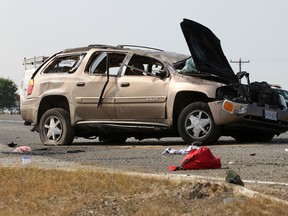 Clothes and personal belongings surround a GMC Envoy that was involved in a motor vehicle collision with a Saturn Aura on Highway #3 and County Road #27 Wednesday, July 18, 2012.  Five people, all occupants of a GMC Envoy, have been rushed to Hotel-Dieu Grace Hospital.  (DAX MELMER/The Windsor Star).