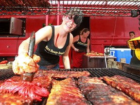 AMHERSTBURG, ONT.:JULY, 24, 2011 -- Chelsea Jarrett smothers some ribs in barbecue sauce at the Horn Dawgs Smokin BBQ stand at last year's Amherstburg Ribfest, Sunday, July 24, 2011.  (DAX MELMER / The Windsor Star)