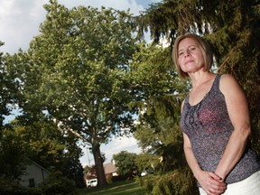 Shyrl Hall, a resident of Roseland Drive west, is pictured in front of a sycamore tree that is at the centre of a debate over whether is should be cut down, Sunday, July 15, 2012.  Hall lives across from the residence where the tree is located.  (DAX MELMER/The Windsor Star).