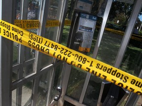 A phone booth on the 300 block of Goyeau Street, north of the Ontario Travel Information Centre, is wrapped with police tape after a bomb threat at the Windsor-Detroit tunnel was called in, Thursday, July 12, 2012.  (DAX MELMER/The Windsor Star).