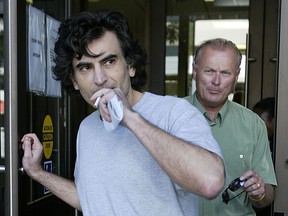 Former Toronto police officer, Ned Maodus,(Grey shirt) and his brother-in-law Robert Brown, (green) leave Superior Court in this 2007 file photo. (The Windsor Star)