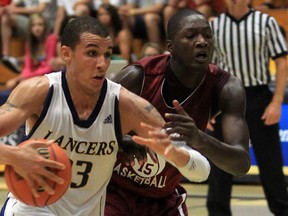 Lancers forward Jahmal McQueen, left, drives past Virgina Tech's Victor Davila during exhibition basketball action at the St. Denis Centre last year.