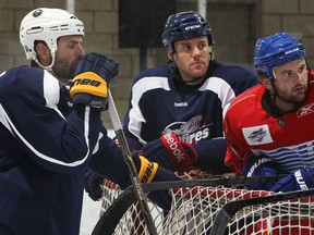 NHLers Mike Weber, from left, Dalton Prout and Zack Kassian chat for a moment before a workout at the WFCU Centre Monday. (NICK BRANCACCIO/The Windsor Star)