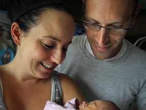 Elena Marcovecchio is held by her parents Steve and Michelle Marcovecchio at the Windsor Regional Hospital in Windsor, Ont. on Thursday, Aug. 15, 2012. The hospital has seen a spike in the number of births. (The Windsor Star / TYLER BROWNBRIDGE)