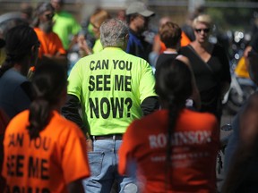 A man wears a shirt that reads 'Can you see me now?' as part of the Windsor-Essex County Motorcycle Awareness Campaign at Anderson Funeral Home in Windsor, Ont., Saturday, August 18, 2012.  (DAX MELMER/The Windsor Star)