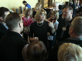 Minister of Education, Laurel Broten, centre, speaks with members of the Ontario English Catholic Teachers Association at Caesars Windsor, Sunday, Mar. 11, 2012. (DAX MELMER/The Windsor Star)