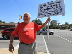 Robert Matis holds a one-man demonstration Tuesday, Aug. 7, 2012, at the corner of Ouellette and Gilles in Windsor, Ont. The Windsor Spitfire fan is pleading to the public to encourage Cogeco Cable to reconsider their decision to release the personnel that covered the Junior A games. (Windsor Star / DAN JANISSE)