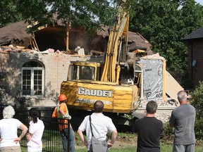 In this file photo, a house at 6645 St. Michaels Drive in LaSalle, Ont. is demolished Wednesday, Aug. 8, 2012. A large marijuana grow operation was discovered at the home in 2011. The neighbours on each immediate side of the home purchased the property and decided to have it levelled.  (Windsor Star / DAN JANISSE)