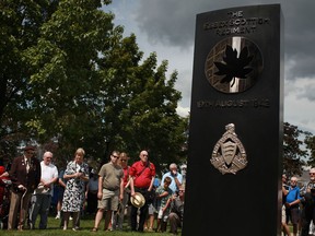 A crowd surrounds the monument to the Essex Scottish Regiment at Dieppe Gardens in Windsor, Ont., during a ceremony marking the anniversary of Dieppe, Sunday, Aug. 19, 2012.  (DAX MELMER/The Windsor Star)