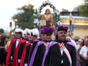 Hundreds walk during a candlelight procession for the 25th anniversary of the St. Angela Merici Festival on Erie Street Sunday, August 12, 2012 in Windsor, Ont. (KRISTIE PEARCE/THE WINDSOR STAR)