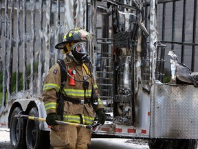 Firefighters extinguish a trailer fire in the 2700 block of Chandler Road in Windsor on Monday, August 20, 2012. The fire was caused by a small paint leak which came in contact with a pump exhaust. The blaze quickly destroyed the trailer and cause damage to a nearby building.             (The Windsor Star / TYLER BROWNBRIDGE)