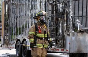 Firefighters extinguish a trailer fire in the 2700 block of Chandler Road in Windsor on Monday, August 20, 2012. The fire was caused by a small paint leak which came in contact with a pump exhaust. The blaze quickly destroyed the trailer and cause damage to a nearby building.             (The Windsor Star / TYLER BROWNBRIDGE)