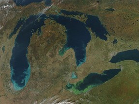 The green scum shown in this image is the worst algae bloom Lake Erie has experienced in decades. Such blooms were common in the lake's shallow western basin in the 1950s and '60s. Phosphorus from farms, sewage and industry fertilized the waters so that huge algae blooms developed year after year. (The Windsor Star-NASA Handout Photo)