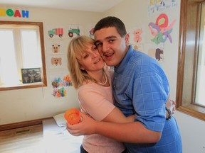In this file photo, Michelle Helou hugs her son Noah, 14 at their Windsor home in Windsor, Ont.  (Jason Kryk/The Windsor Star)
