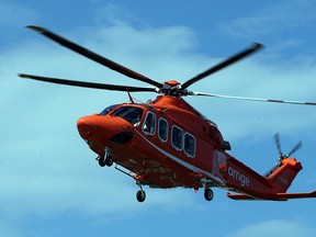 An Ornge helicopter transports a patient to hospital from the Highline Mushroom Plant in Kingsville, Ont., in this 2012 file photo. (TYLER BROWNBRIDGE/The Windsor Star)