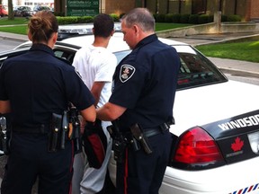 Windsor police arrest a young man outside an apartment building at 500 Windsor Ave. following a stabbing call there shortly after 6:30 p.m. Tuesday, Aug. 21, 2012. A teen-aged male suffering a stab wound to the back was rushed to hospital. (Doug Schmidt / The Windsor Star)