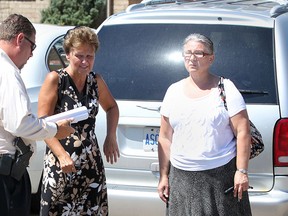 A LaSalle police detective speaks with two people present at the time of a near drowning of a young boy at 2701 Lombardy Crescent in LaSalle, Ont., Tuesday, Aug. 7, 2012. (DAX MELMER/The Windsor Star)