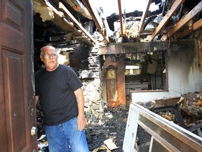 Robin Sheardown poses in his Tecumseh, Ont. home Friday, Aug. 10, 2012, after it was gutted by a fire. He and dog and bird escaped the fire. (Windsor Star / DAN JANISSE)